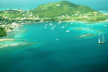 This photo of Clifton Harbor at Union Island in the Grenadines (part of the Caribbean island nation of St Vincent and the Grenadines) was taken by Iain Grant and is used courtesy of the GNU Free Documentation License. (http://commons.wikimedia.org/wiki/File:CliftonAerialView.jpg)